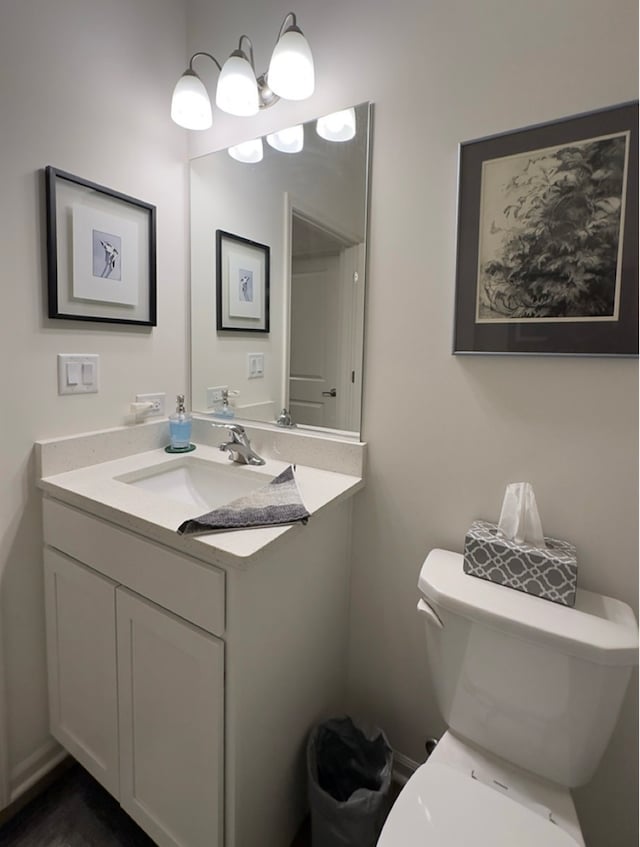 bathroom featuring vanity and toilet