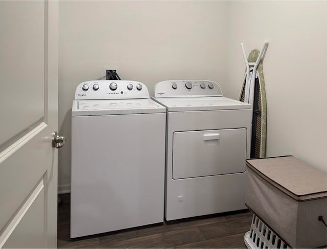 laundry room with washer and clothes dryer and dark wood-type flooring