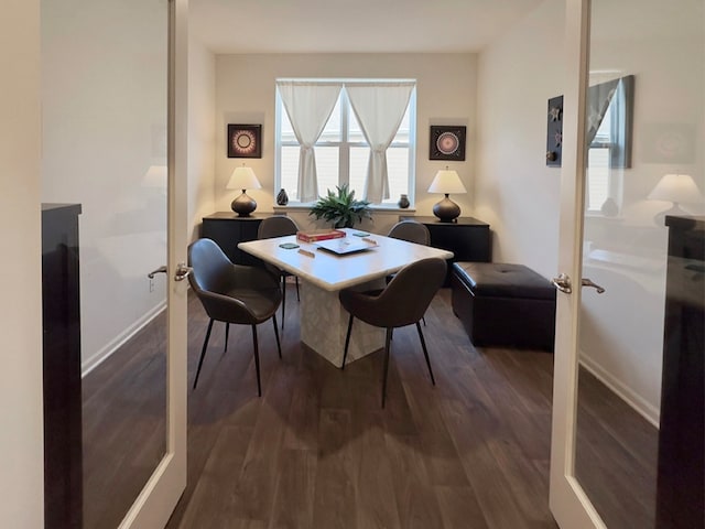 dining space featuring dark hardwood / wood-style floors and french doors