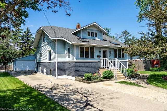 view of front facade featuring a front lawn, an outdoor structure, and a garage