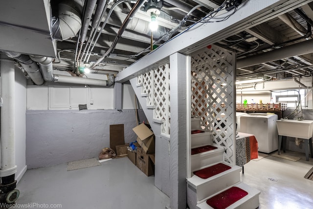 basement featuring sink and washing machine and dryer