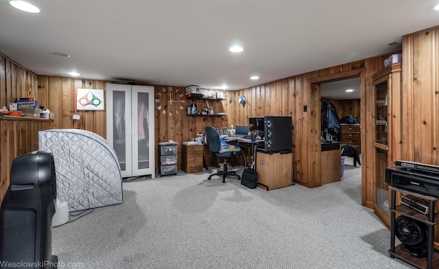 carpeted office space with wood walls