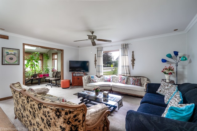 living room featuring ceiling fan, light colored carpet, and crown molding