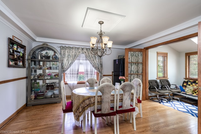 dining space with wood-type flooring, a chandelier, and a wealth of natural light