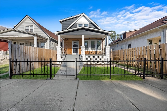 bungalow-style home featuring a front yard and covered porch