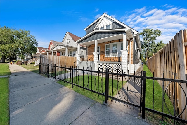 view of front of property with a front yard and a porch