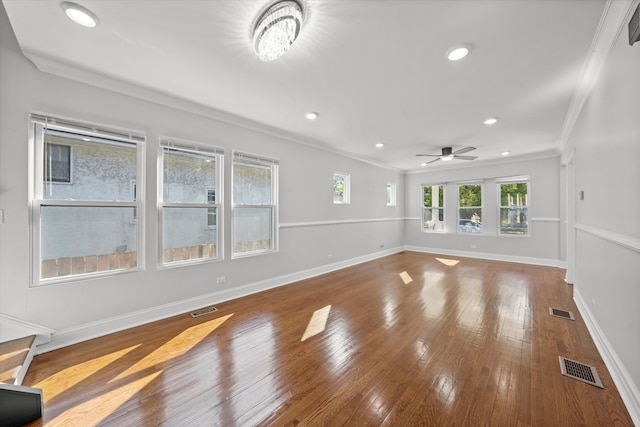 unfurnished living room featuring ceiling fan, crown molding, and wood-type flooring