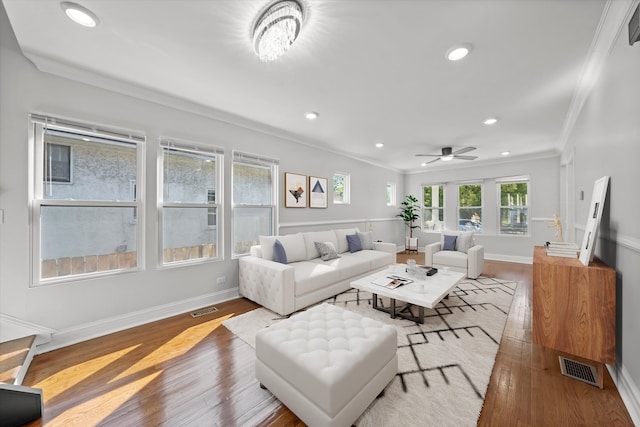 living room with ornamental molding, ceiling fan, and hardwood / wood-style flooring