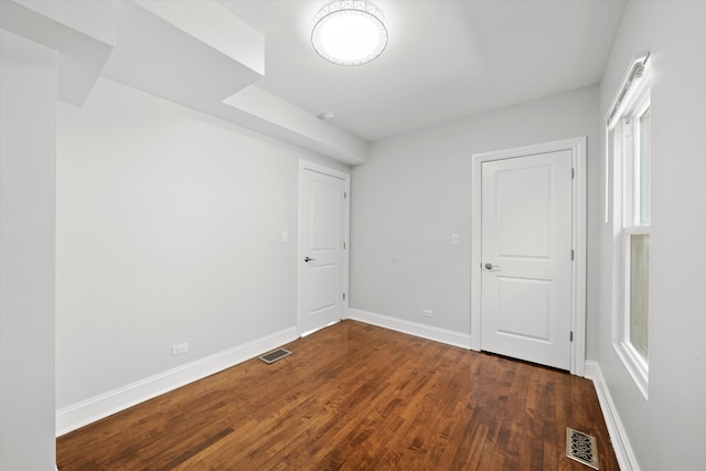 empty room featuring dark hardwood / wood-style flooring