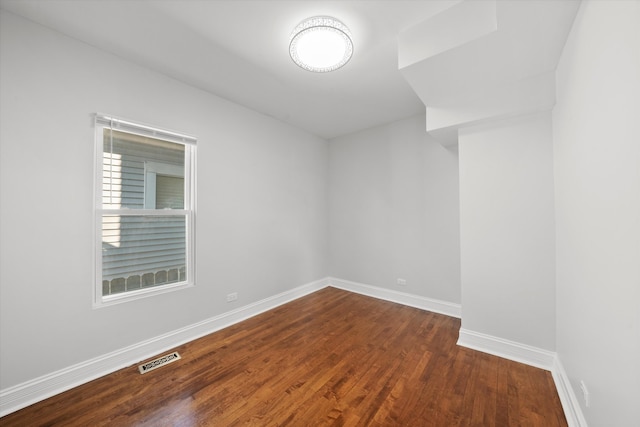 unfurnished room featuring dark hardwood / wood-style floors