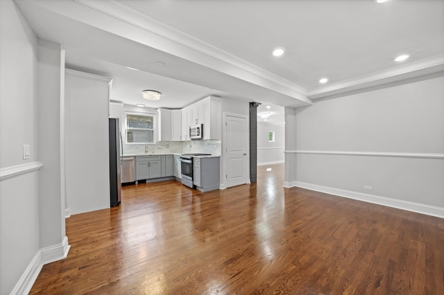 unfurnished living room with crown molding, hardwood / wood-style floors, and sink