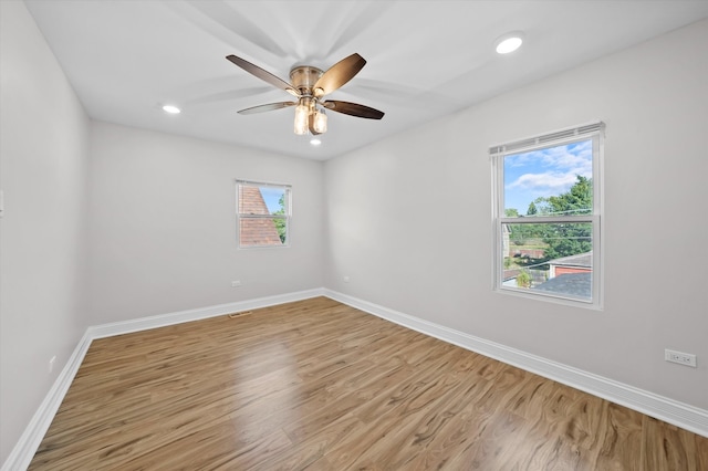 unfurnished room featuring ceiling fan, light hardwood / wood-style flooring, and plenty of natural light