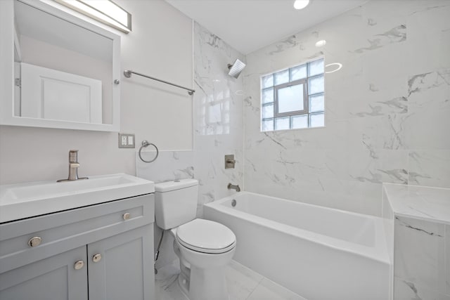 full bathroom featuring tiled shower / bath, vanity, and toilet