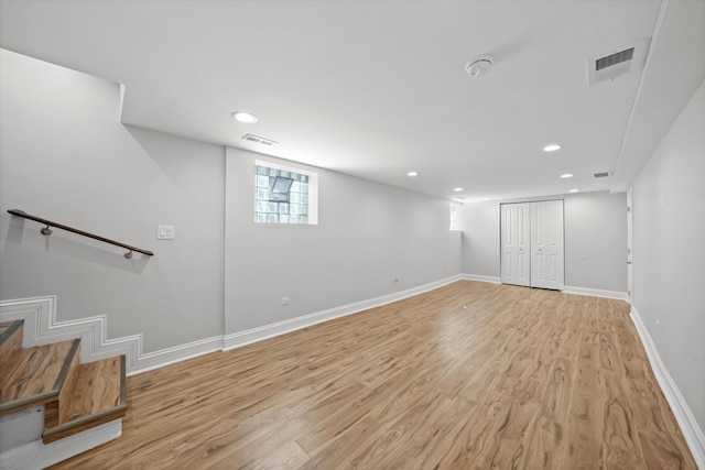 basement with light hardwood / wood-style flooring