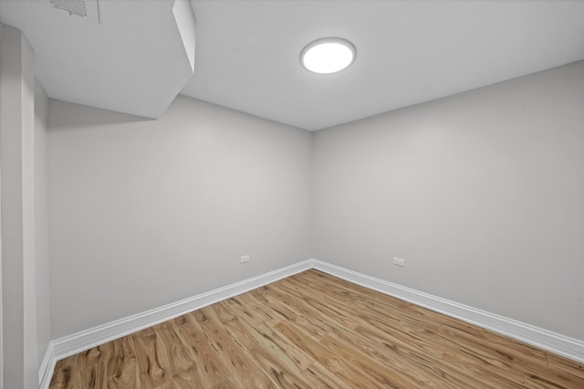 unfurnished room with wood-type flooring