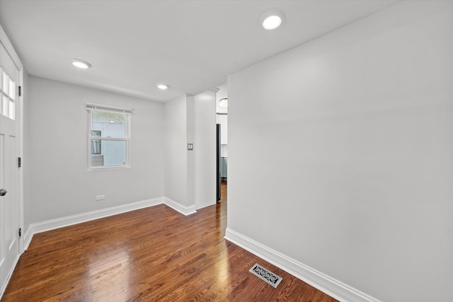 unfurnished room with dark hardwood / wood-style floors