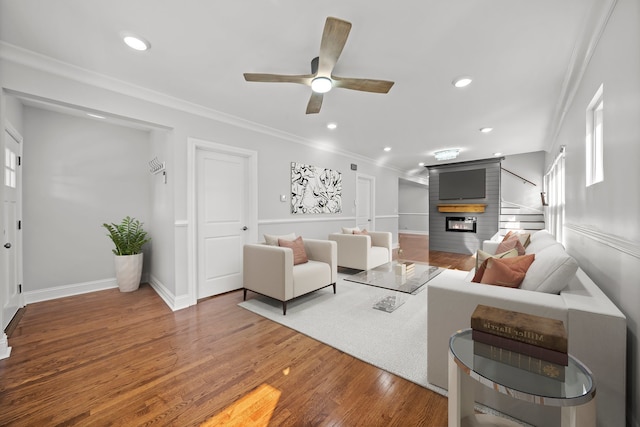 living room featuring ceiling fan, crown molding, and hardwood / wood-style floors