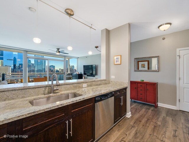 757 N Orleans St Unit 1612, Chicago, IL 60654 - kitchen featuring stainless steel dishwasher, a sink, dark wood-style floors, decorative light fixtures, and light stone countertops