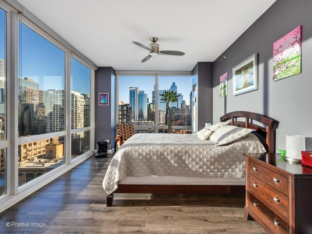 757 N Orleans St Unit 1612, Chicago, IL 60654 - bedroom with a view of skyline, wood finished floors, floor to ceiling windows, and ceiling fan