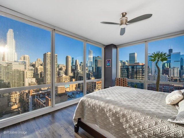 757 N Orleans St Unit 1612, Chicago, IL 60654 - bedroom featuring expansive windows, a view of skyline, wood finished floors, and multiple windows