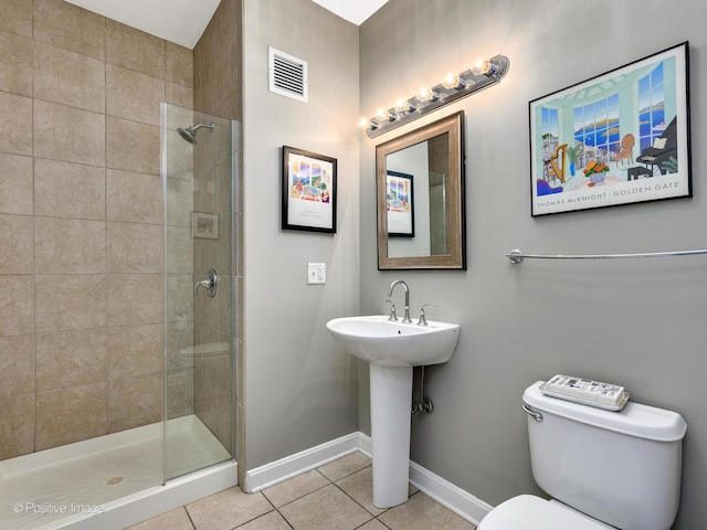 757 N Orleans St Unit 1612, Chicago, IL 60654 - full bathroom with tile patterned floors, toilet, a tile shower, baseboards, and a sink