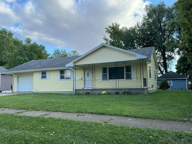 view of front of house featuring a front yard, a porch, and a garage