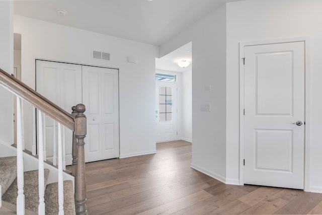 foyer entrance with light hardwood / wood-style floors