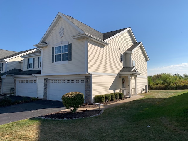 view of side of home featuring a garage and a yard