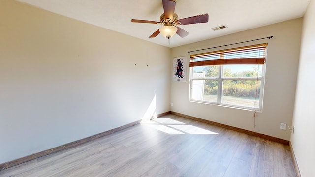 empty room featuring ceiling fan and light hardwood / wood-style floors