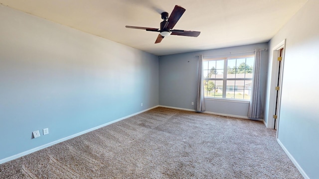 spare room featuring ceiling fan and light carpet