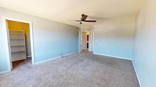 empty room with carpet flooring and ceiling fan