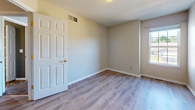 unfurnished bedroom with light wood-type flooring