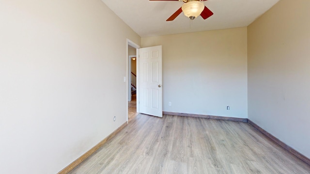 unfurnished room with light wood-type flooring and ceiling fan