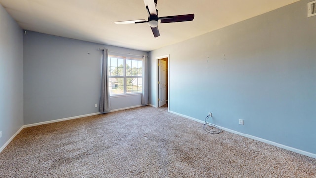 empty room with ceiling fan and carpet flooring