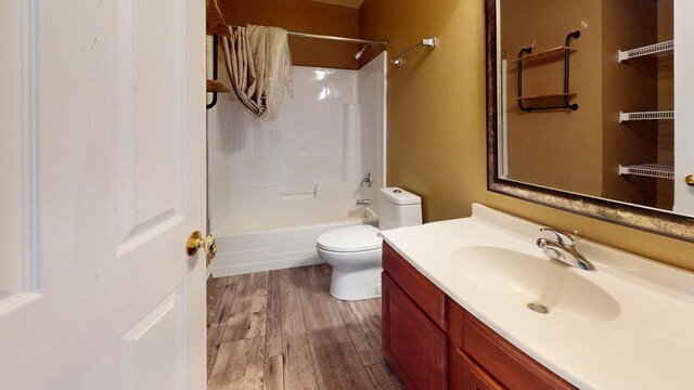 full bathroom with shower / tub combination, vanity, toilet, and hardwood / wood-style flooring