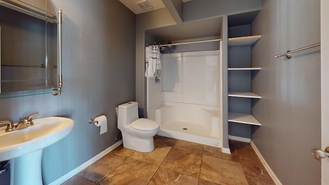 bathroom with sink, toilet, and a shower with shower curtain