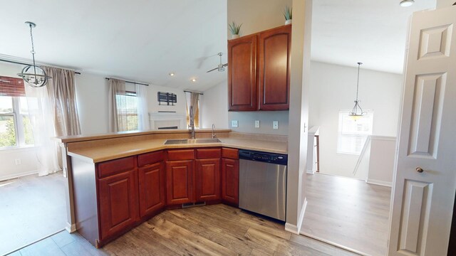 kitchen featuring a wealth of natural light, decorative light fixtures, and stainless steel dishwasher