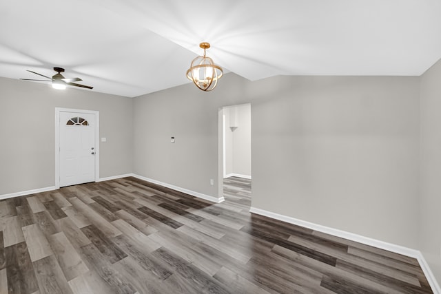 interior space featuring ceiling fan with notable chandelier, dark hardwood / wood-style floors, and lofted ceiling