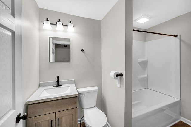 full bathroom featuring  shower combination, vanity, and toilet