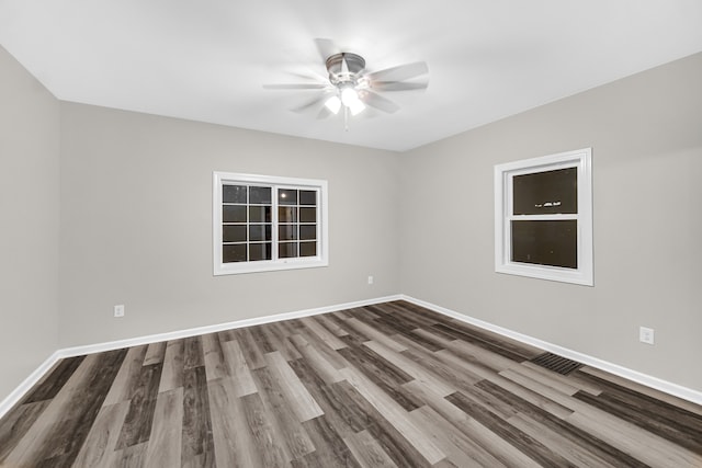 spare room featuring hardwood / wood-style floors and ceiling fan