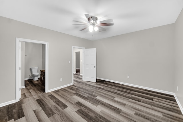 unfurnished bedroom featuring wood-type flooring, ensuite bath, and ceiling fan