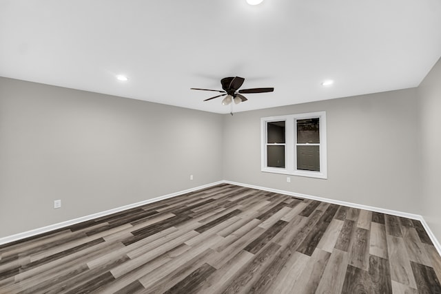 spare room featuring wood-type flooring and ceiling fan