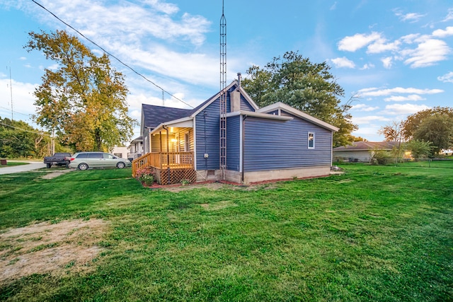 rear view of property featuring a lawn