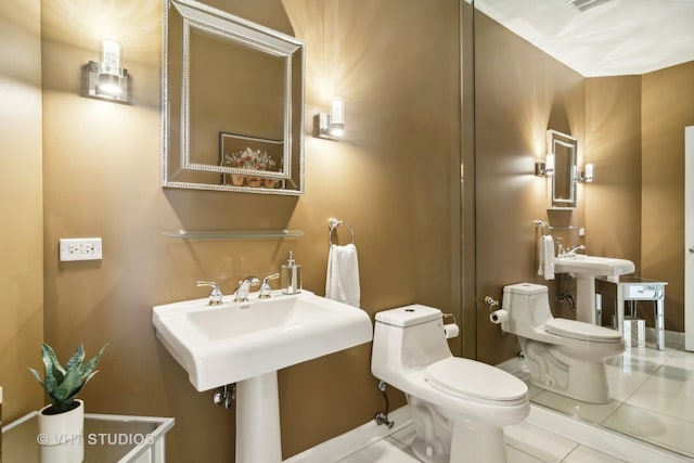 bathroom with tile patterned flooring and toilet