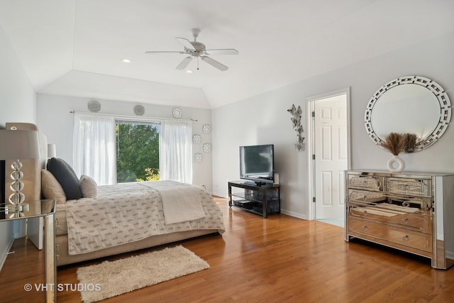 bedroom with lofted ceiling, hardwood / wood-style floors, and ceiling fan