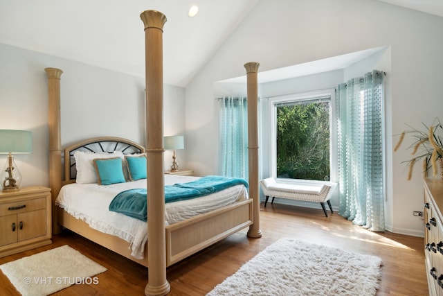 bedroom with light hardwood / wood-style floors and high vaulted ceiling