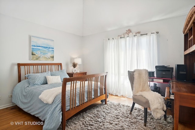 bedroom with hardwood / wood-style floors