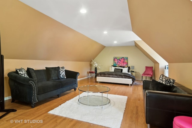 living room featuring lofted ceiling and hardwood / wood-style floors