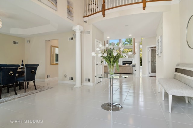 tiled foyer featuring ornate columns