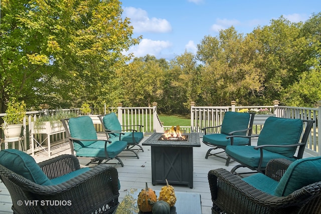 wooden deck with an outdoor living space with a fire pit